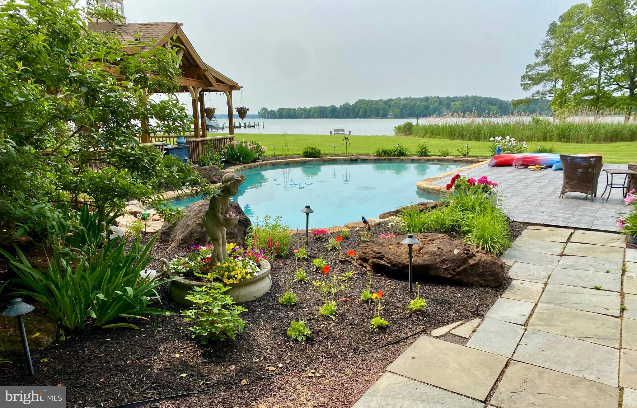 23961 Lynnewood Drive St. Michaels, MD 21663 - Photo 68 of 81 a view of a swimming pool with an outdoor seating