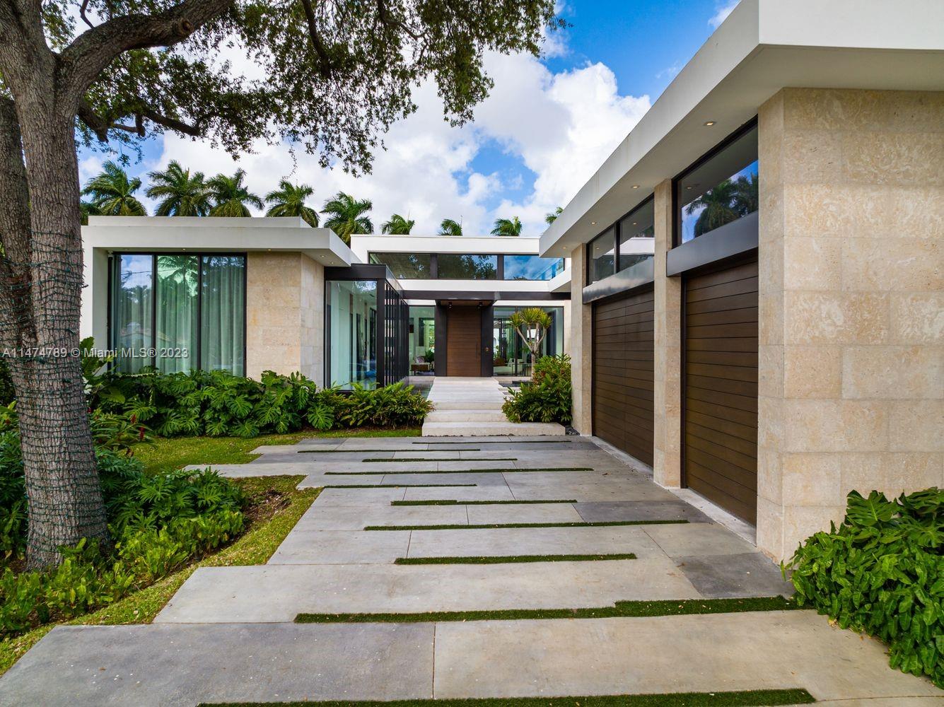 a front view of a house with a garden