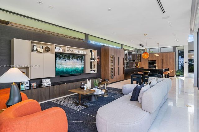 a room with furniture pool table and flat screen tv