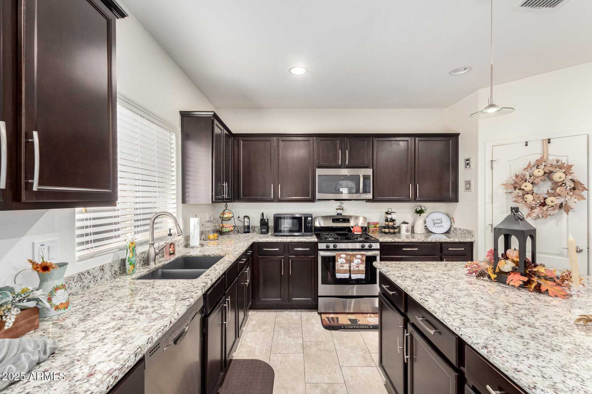 2665 East Gillcrest Road Gilbert, AZ 85298 - Photo 16 of 48 a kitchen with stainless steel appliances granite countertop a sink stove and refrigerator