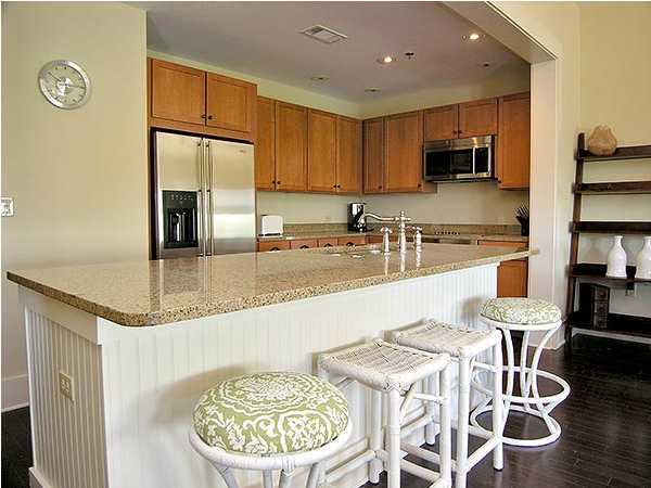 2046 Hwy Santa Rosa Beach, Unit M2321 30A Santa Rosa Beach, FL 32459 - Photo 2 of 14 a kitchen with stainless steel appliances granite countertop a sink a stove a kitchen island with chairs and wooden floor