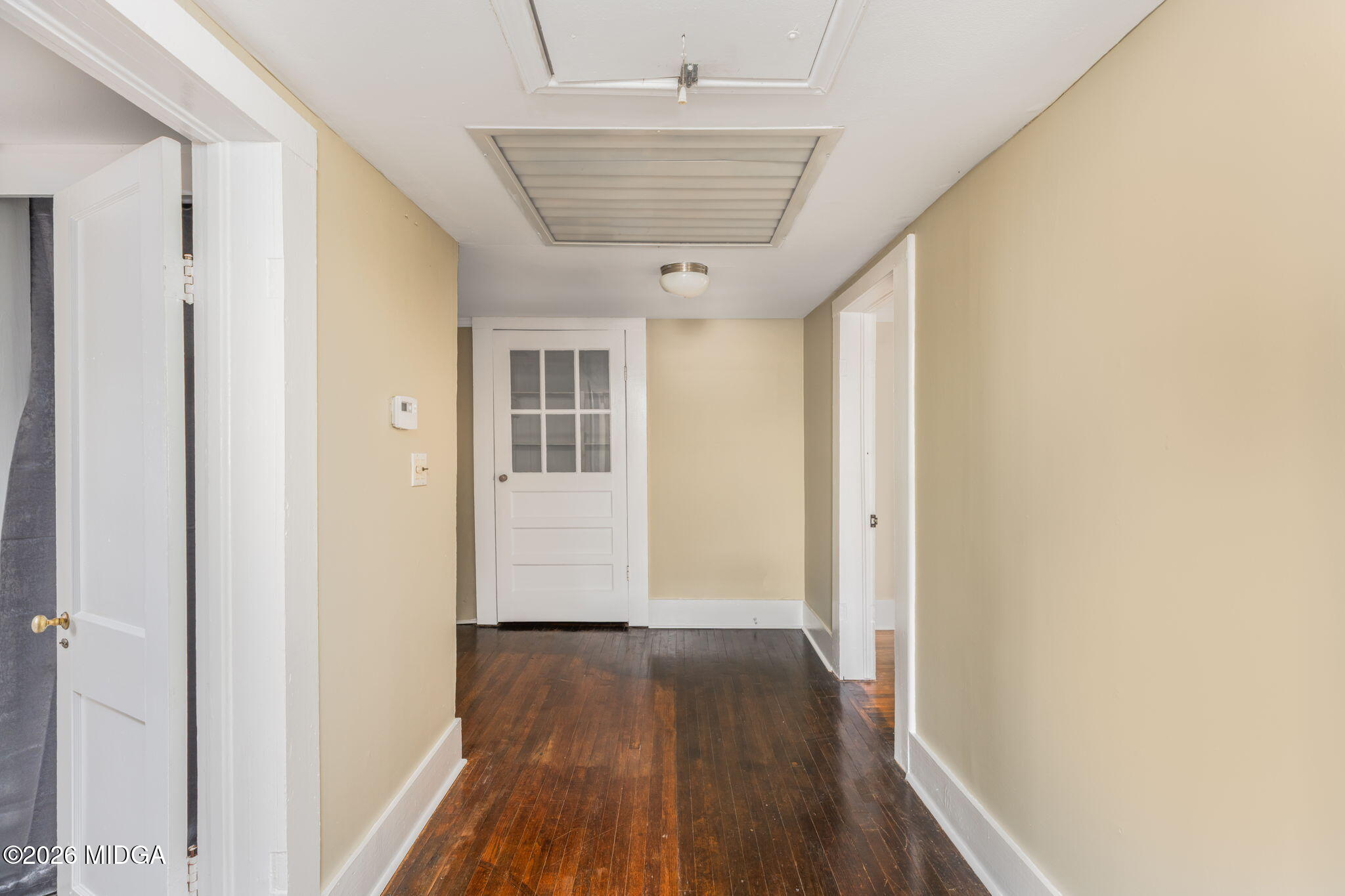 107 Childs Street Gray, GA 31032 - Photo 25 of 37 a view of a hallway with wooden floor and a kitchen