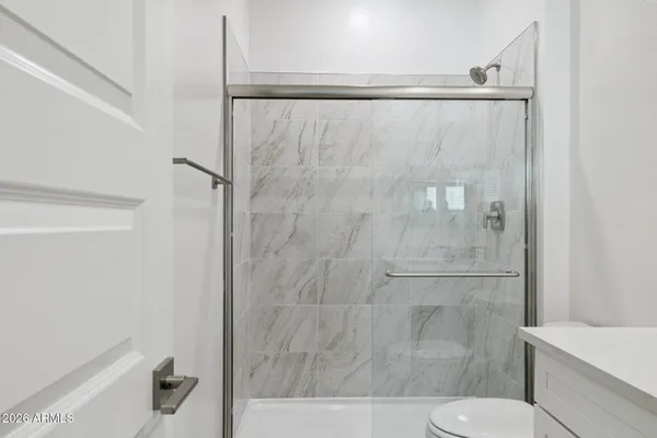 a white toilet sitting next to a bathroom sink