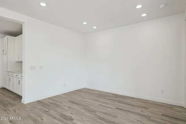 a view of empty room with wooden floor