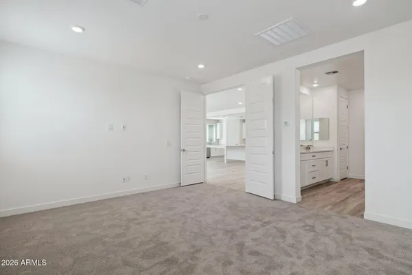 wooden floor in a room with a bathroom