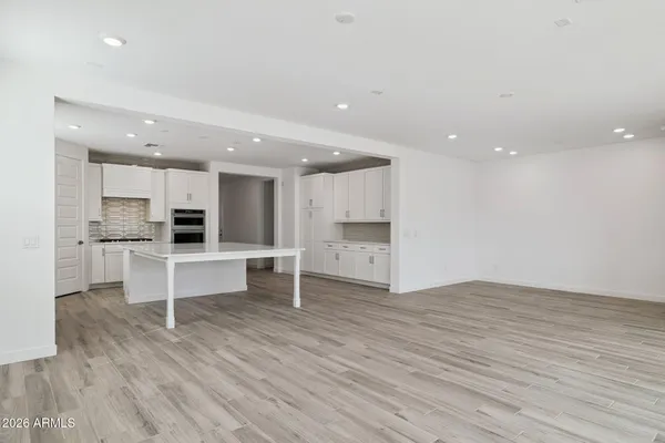 a view of kitchen with wooden floor and electronic appliances