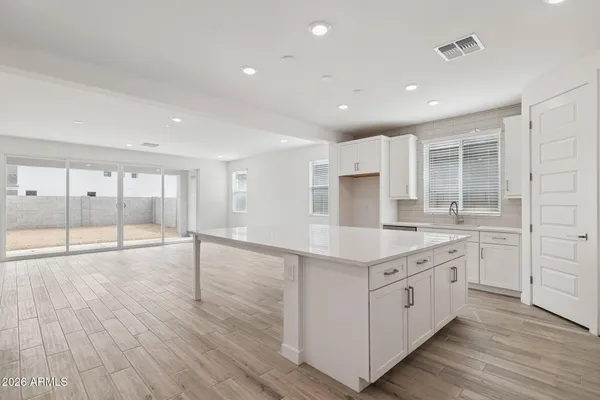 a large kitchen with stainless steel appliances granite countertop a large stove a sink and dishwasher with wooden floor