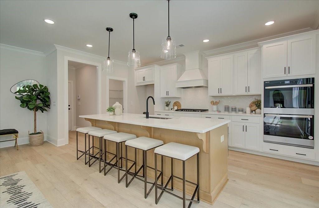 a kitchen with stainless steel appliances kitchen island a table and chairs in it