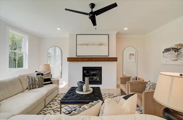 a living room with furniture a fireplace and a window