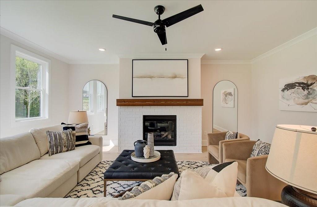 302 Evie Lane Canton, GA 30115 - Photo 11 of 45 a living room with furniture a fireplace and a window