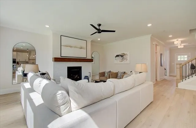 a living room with furniture a fireplace and a flat screen tv