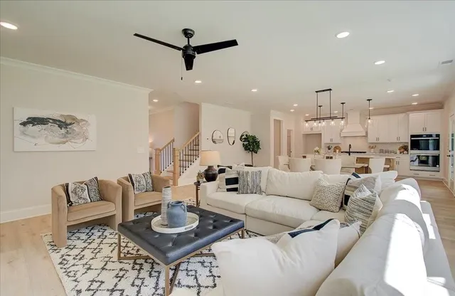a living room with furniture and a view of kitchen