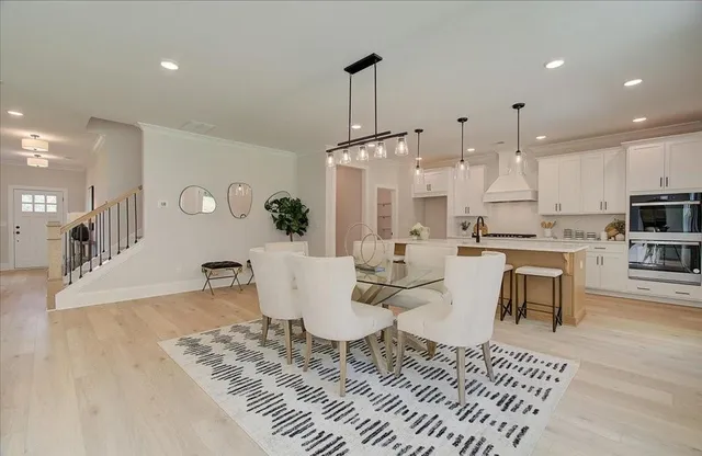 a large kitchen with a table and chairs