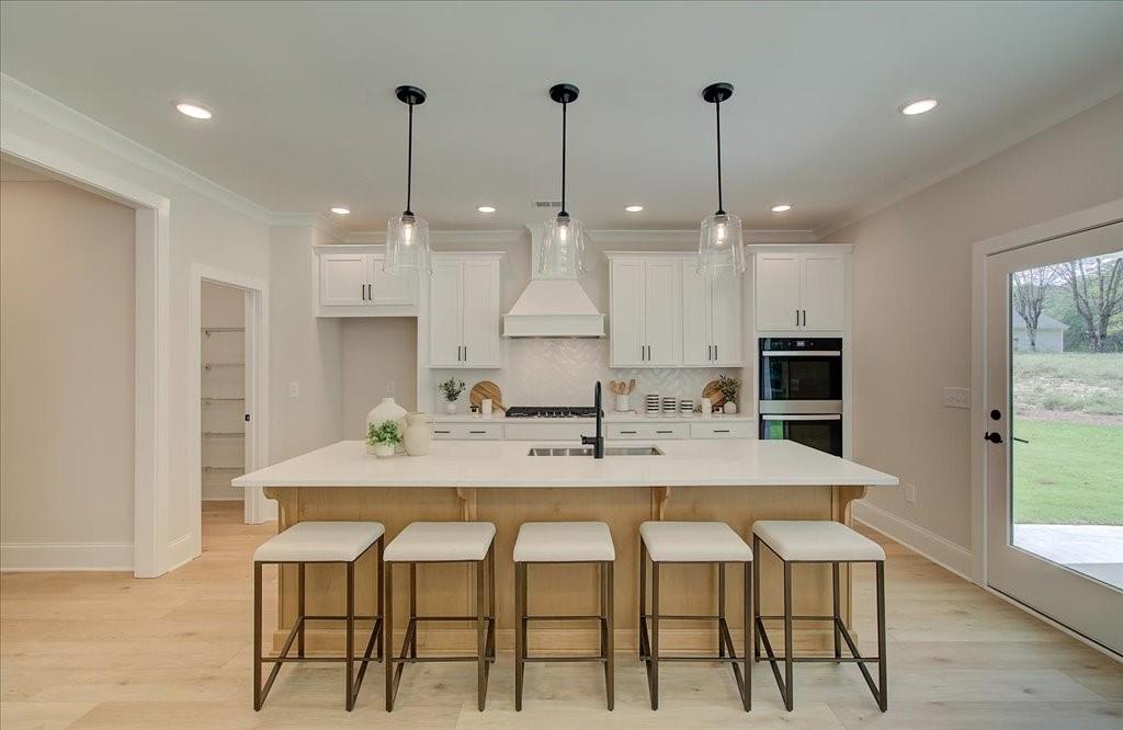 302 Evie Lane Canton, GA 30115 - Photo 19 of 45 a view of a kitchen with a dining table chairs sink and wooden floor