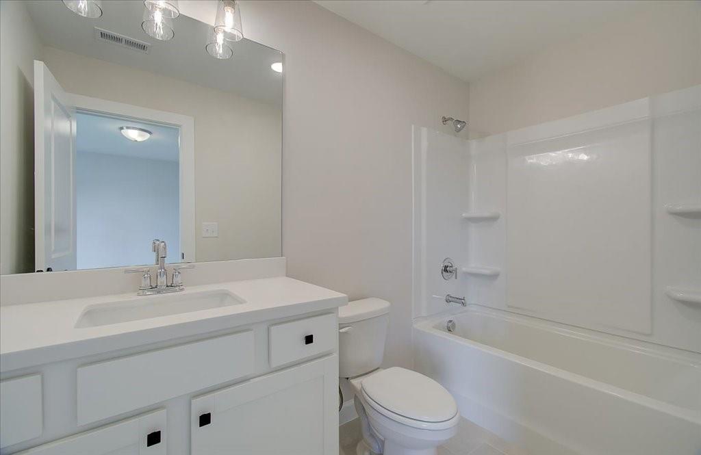 302 Evie Lane Canton, GA 30115 - Photo 28 of 45 a bathroom with a sink a toilet and shower