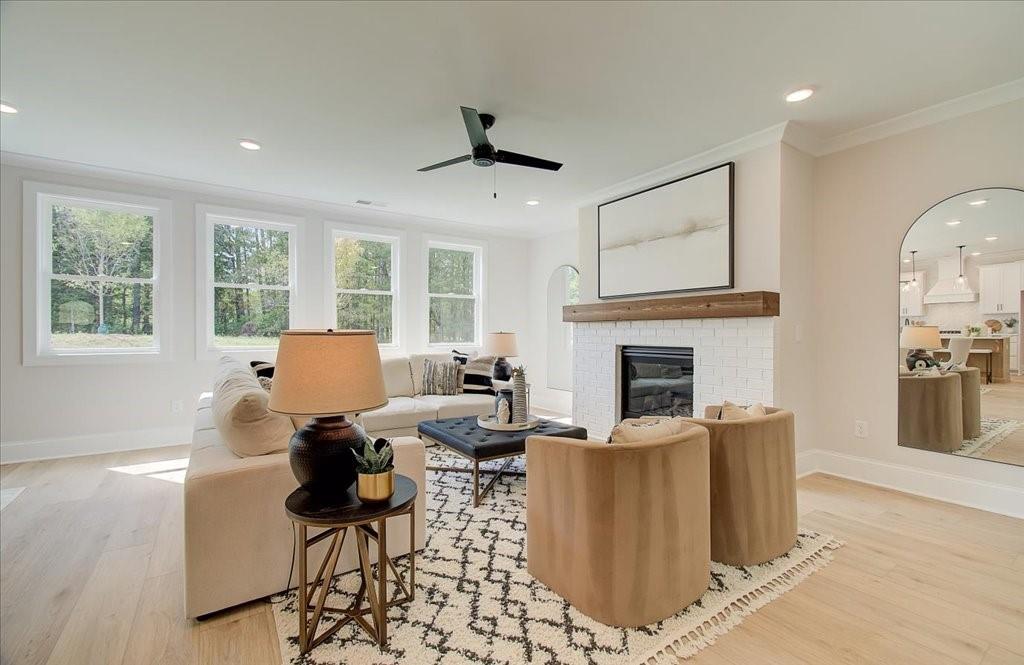 302 Evie Lane Canton, GA 30115 - Photo 3 of 45 a living room with fireplace furniture and a large window
