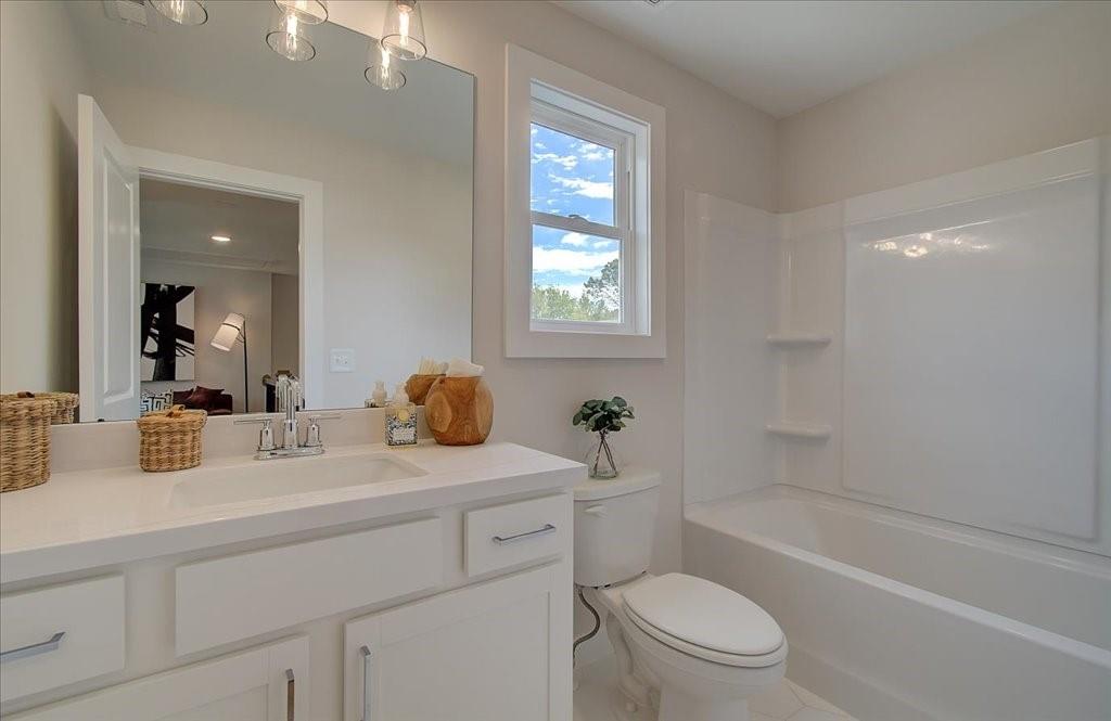 302 Evie Lane Canton, GA 30115 - Photo 31 of 45 a bathroom with a sink a toilet and shower