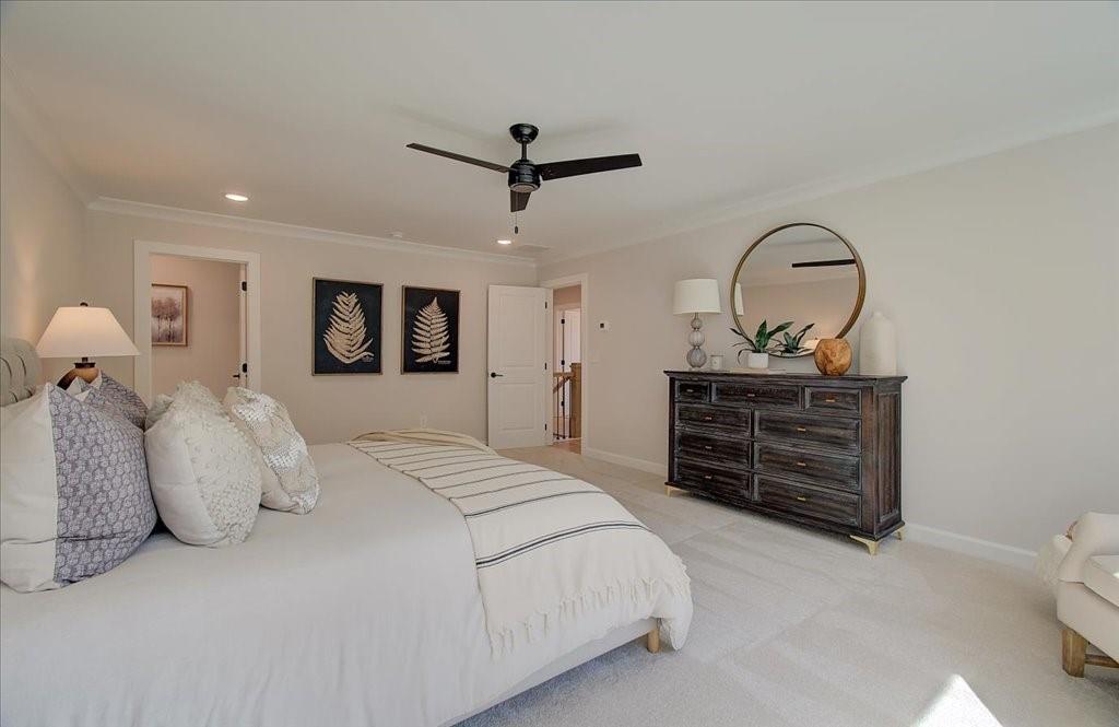 302 Evie Lane Canton, GA 30115 - Photo 35 of 45 a spacious bedroom with a bed a dresser and a dresser