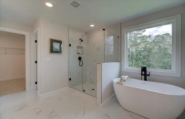 a bathroom with a bathtub and a shower