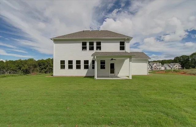 a front view of a house with a garden