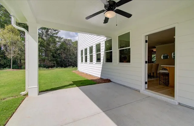 a view of a house with backyard and porch