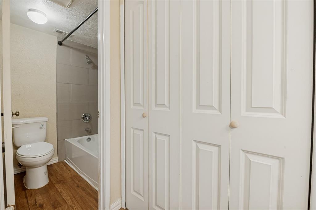 7305 Pineberry Road Dallas, TX 75249 - Photo 20 of 25 a bathroom with a toilet and a shower