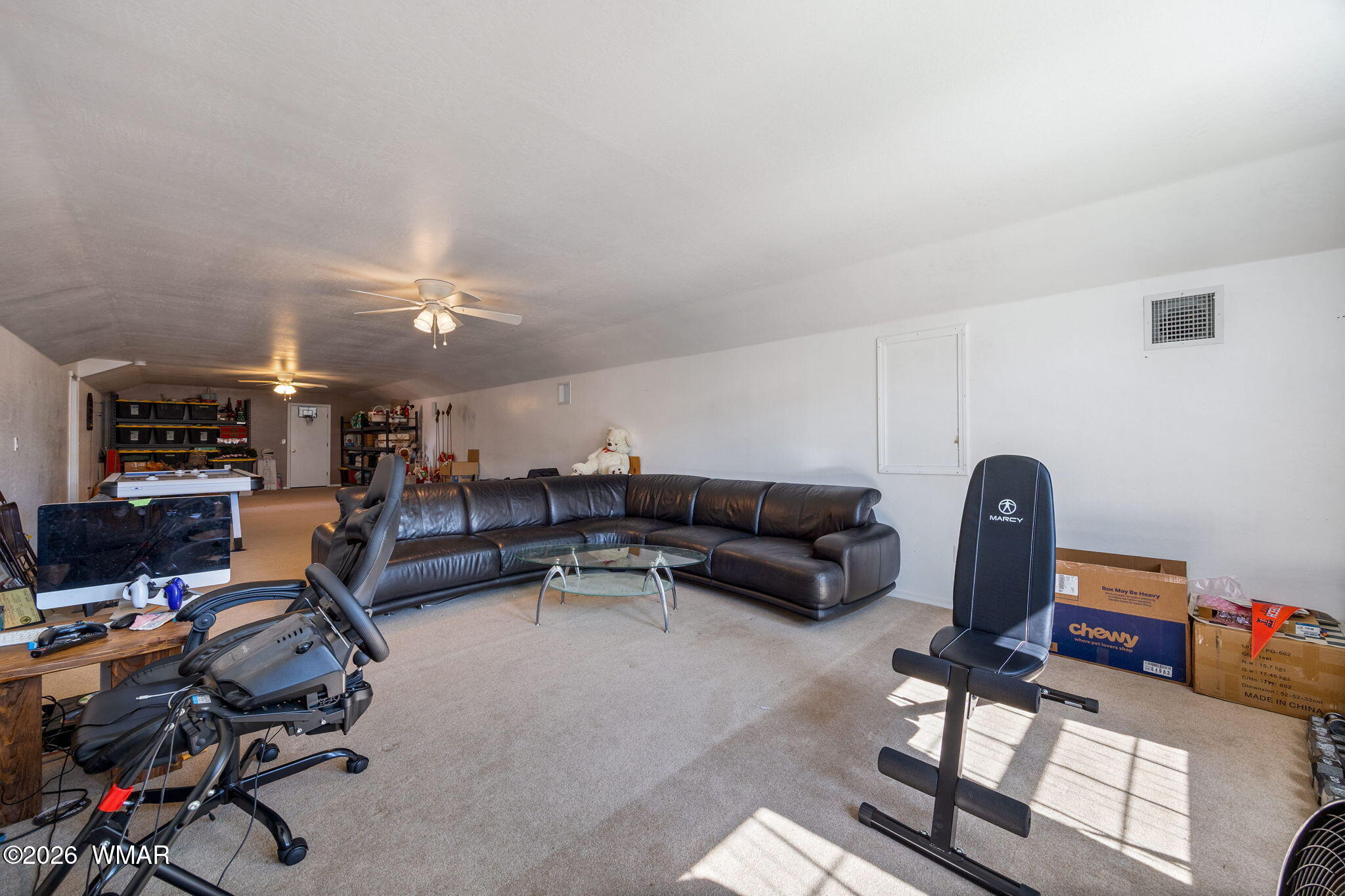 1940 Stonegate Way Heber, AZ 85928 - Photo 43 of 62 a living room with furniture a flat screen tv and gym equipment