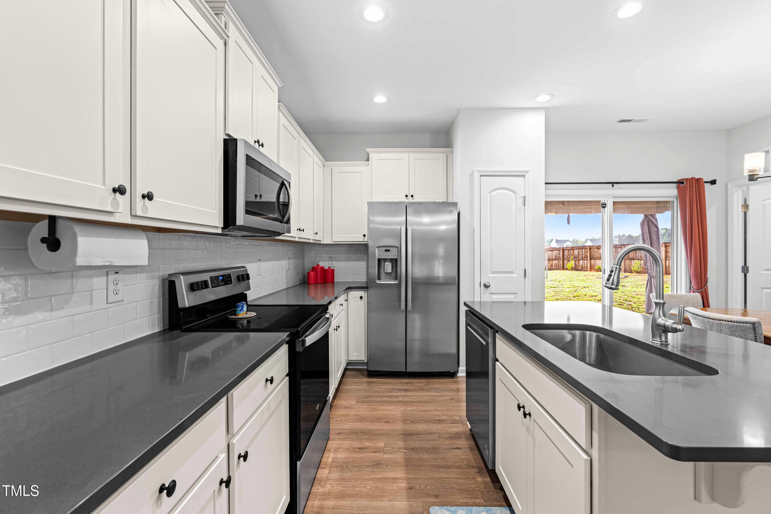 173 Longbow Drive Middlesex, NC 27557 - Photo 17 of 32 a kitchen with stainless steel appliances granite countertop a sink refrigerator and cabinets