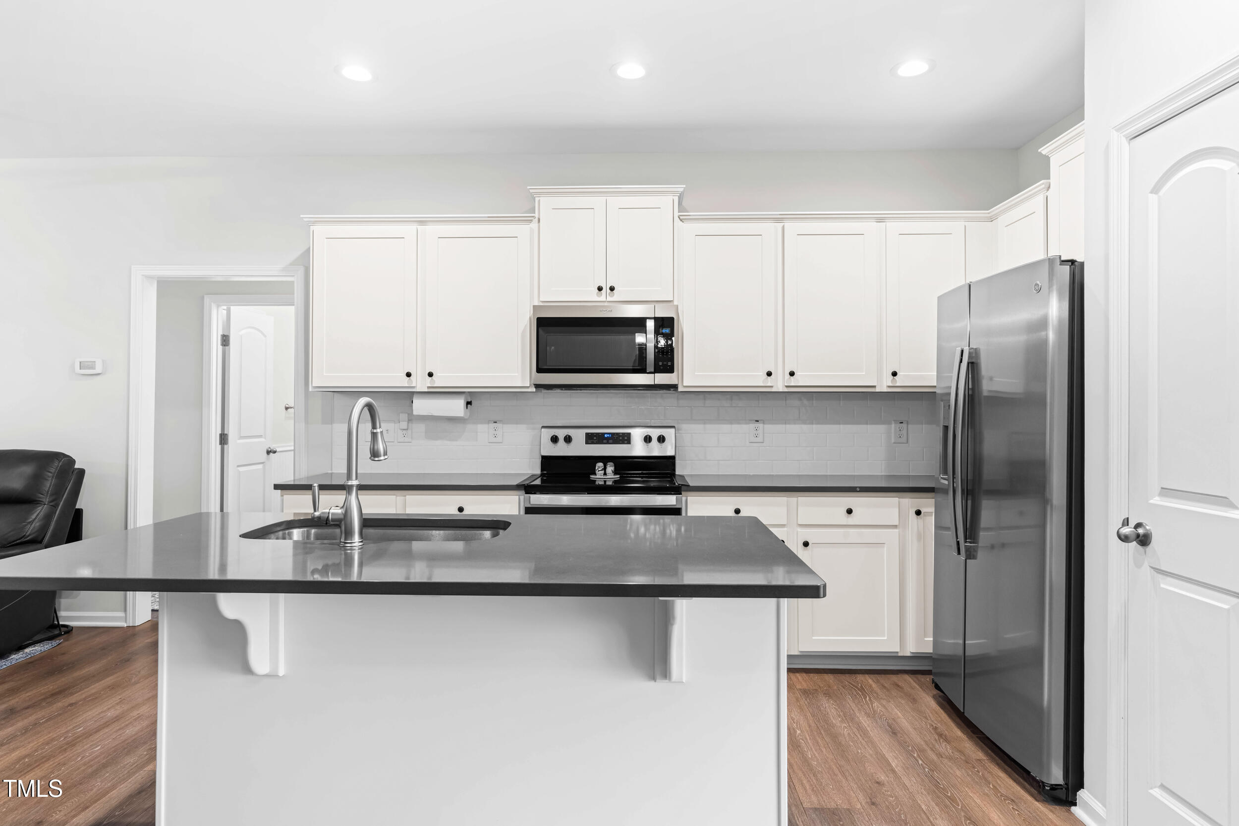 173 Longbow Drive Middlesex, NC 27557 - Photo 18 of 32 a kitchen with stainless steel appliances a refrigerator a stove a sink and a microwave