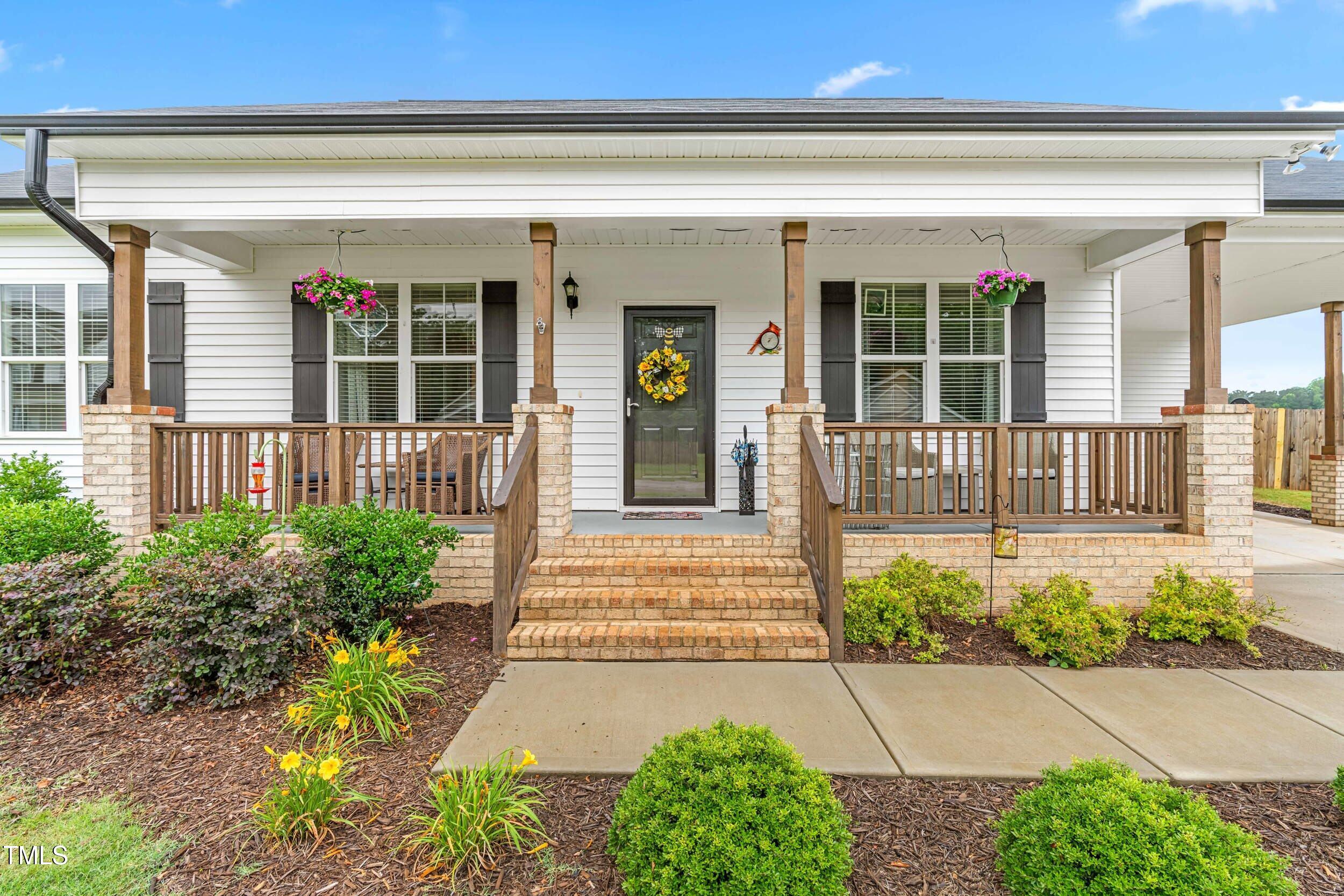 173 Longbow Drive Middlesex, NC 27557 - Photo 2 of 32 a front view of a house with a yard and potted plants