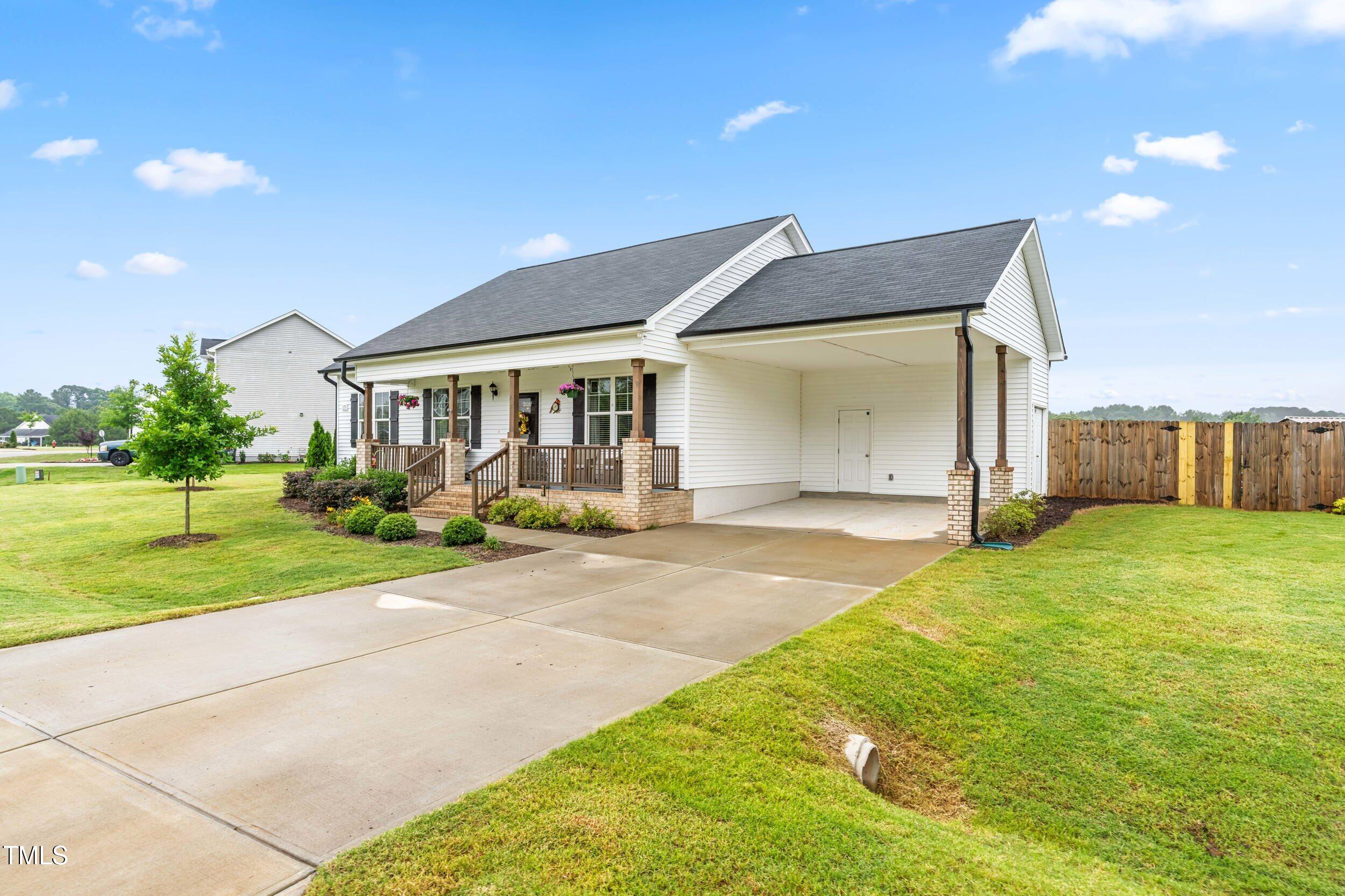 173 Longbow Drive Middlesex, NC 27557 - Photo 4 of 32 a view of a house with backyard and a garden