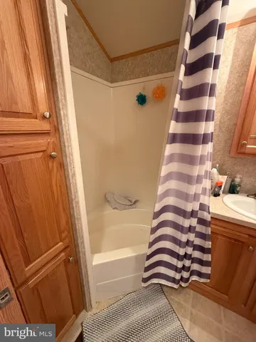 a bathroom with a bathtub and shower