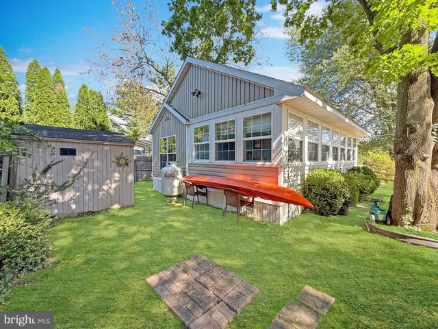 a view of a house with a yard and sitting area