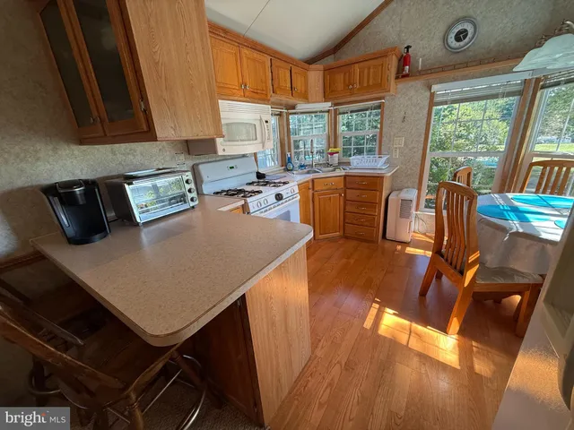 a view of kitchen and dining room with wooden floor
