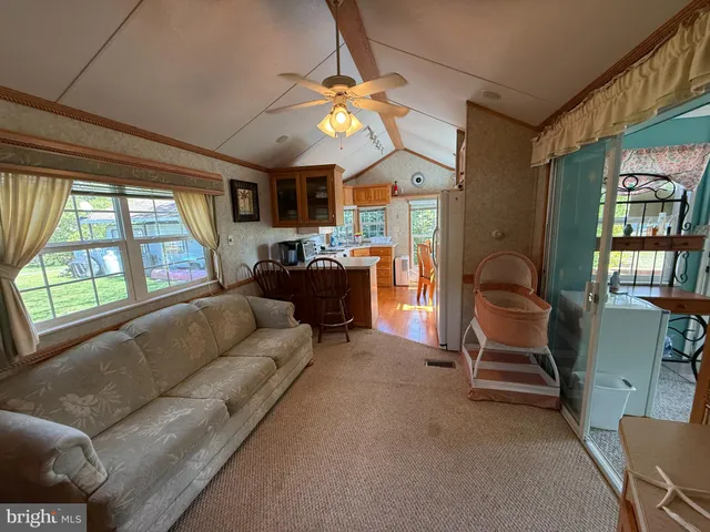 a living room with furniture a window and a flat screen tv