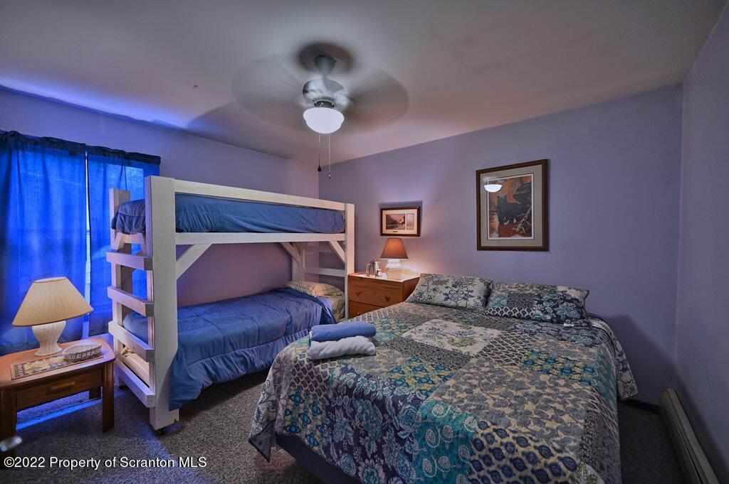 69-71 Timbertop Trail Newfoundland, PA 18445 - Photo 24 of 137 a bedroom with a bed and a chandelier