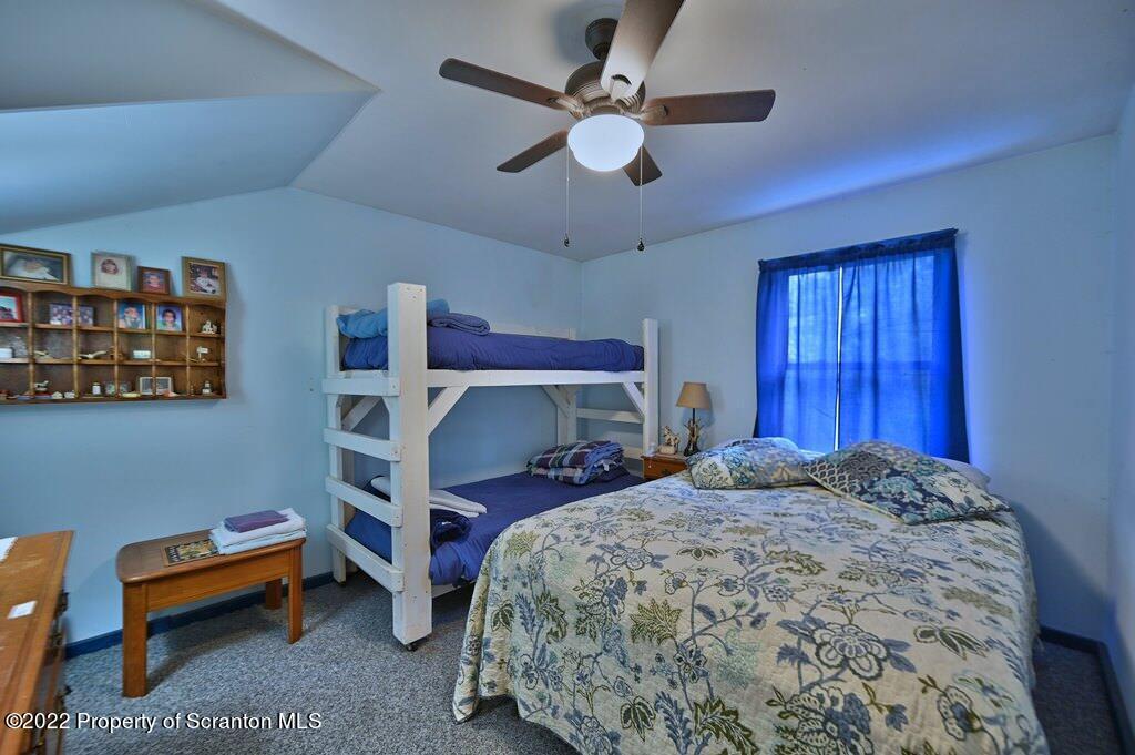69-71 Timbertop Trail Newfoundland, PA 18445 - Photo 27 of 137 a bedroom with a bed and a chandelier