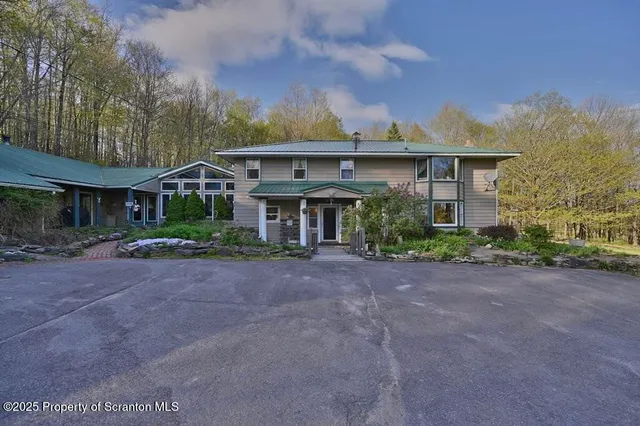 a kitchen with stainless steel appliances granite countertop a stove refrigerator and microwave