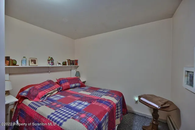 a bedroom with a bed and a table in it