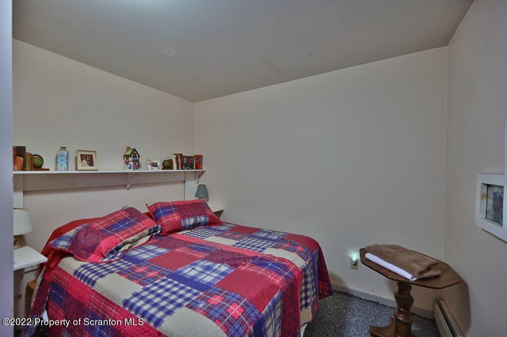 69-71 Timbertop Trail Newfoundland, PA 18445 - Photo 38 of 137 a bedroom with a bed and a chair