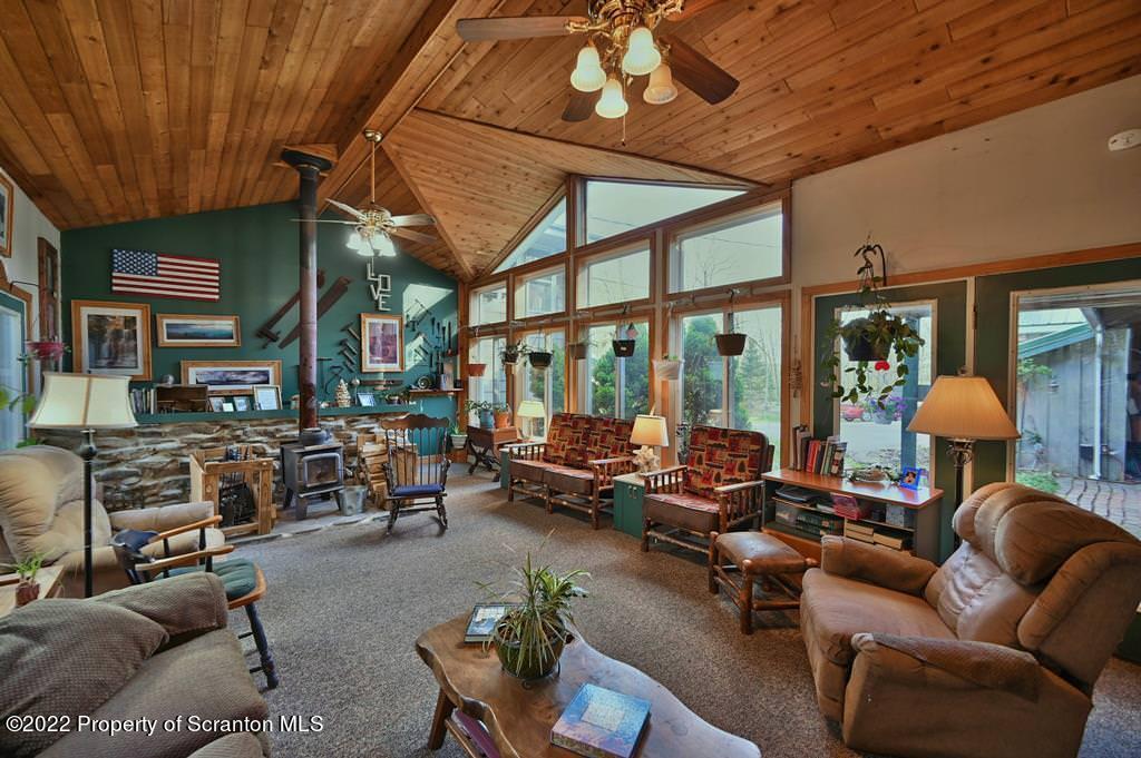 69-71 Timbertop Trail Newfoundland, PA 18445 - Photo 42 of 137 a living room with furniture a fireplace and a flat screen tv