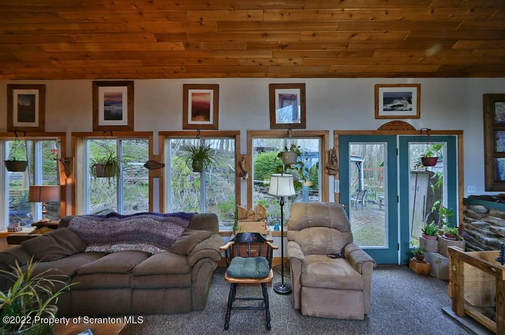69-71 Timbertop Trail Newfoundland, PA 18445 - Photo 46 of 137 a living room with furniture and a floor to ceiling window