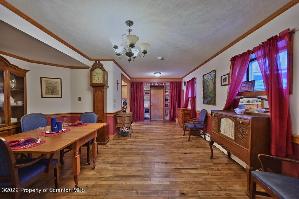69-71 Timbertop Trail Newfoundland, PA 18445 - Photo 49 of 137 a living room with furniture a dining table and paintings on the wall