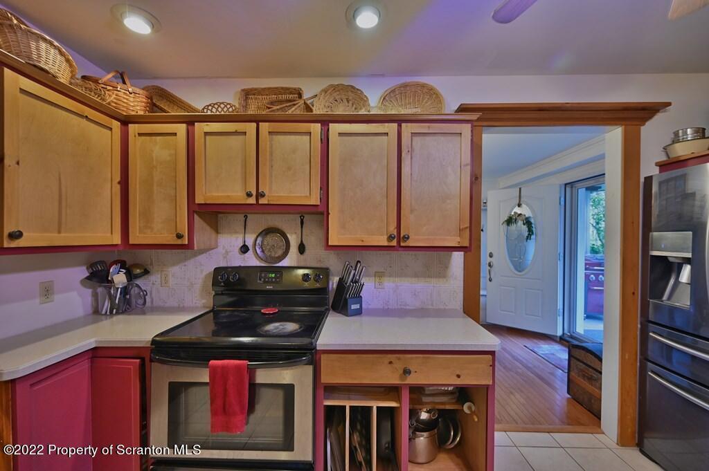 69-71 Timbertop Trail Newfoundland, PA 18445 - Photo 60 of 137 a kitchen with stainless steel appliances granite countertop a stove and cabinets
