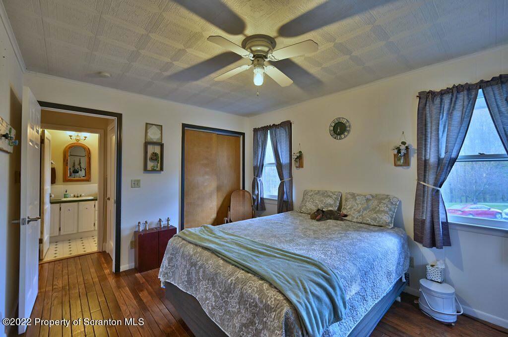 69-71 Timbertop Trail Newfoundland, PA 18445 - Photo 100 of 137 a bedroom with a bed and a chandelier