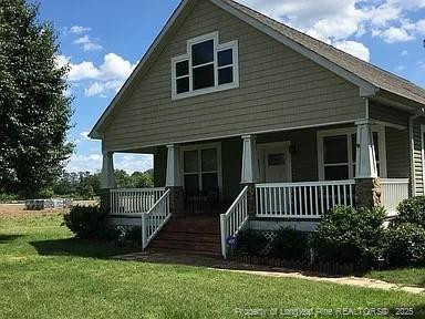 9167 Deep Branch Road Pembroke, NC 28372 - Photo 12 of 24 front view of a house with a yard