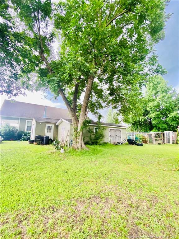 9167 Deep Branch Road Pembroke, NC 28372 - Photo 2 of 24 a front view of a house with a yard and trees