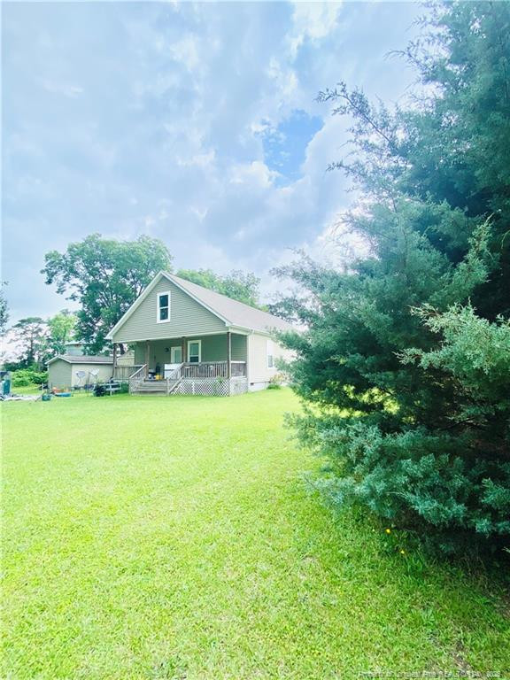 9167 Deep Branch Road Pembroke, NC 28372 - Photo 3 of 24 a yellow and red house with a garden