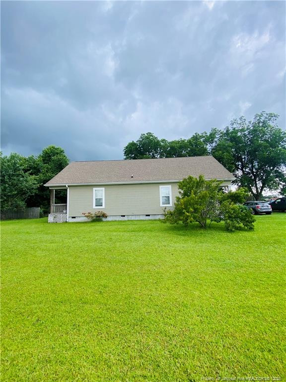 9167 Deep Branch Road Pembroke, NC 28372 - Photo 4 of 24 a backyard of a house with plants and large trees