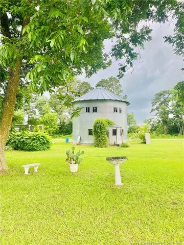 a front view of a house with yard and green space